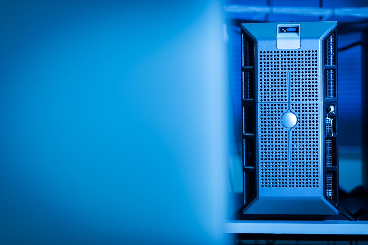 gallery-6 Close-up of a modern server unit in a blue-lit data center environment.